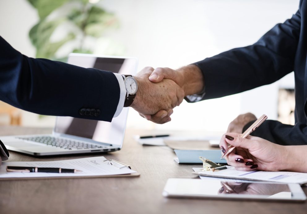 Business people shaking hands together